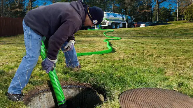 Service technician performing residential septic pumping and drainage maintenance in Shreveport, LA